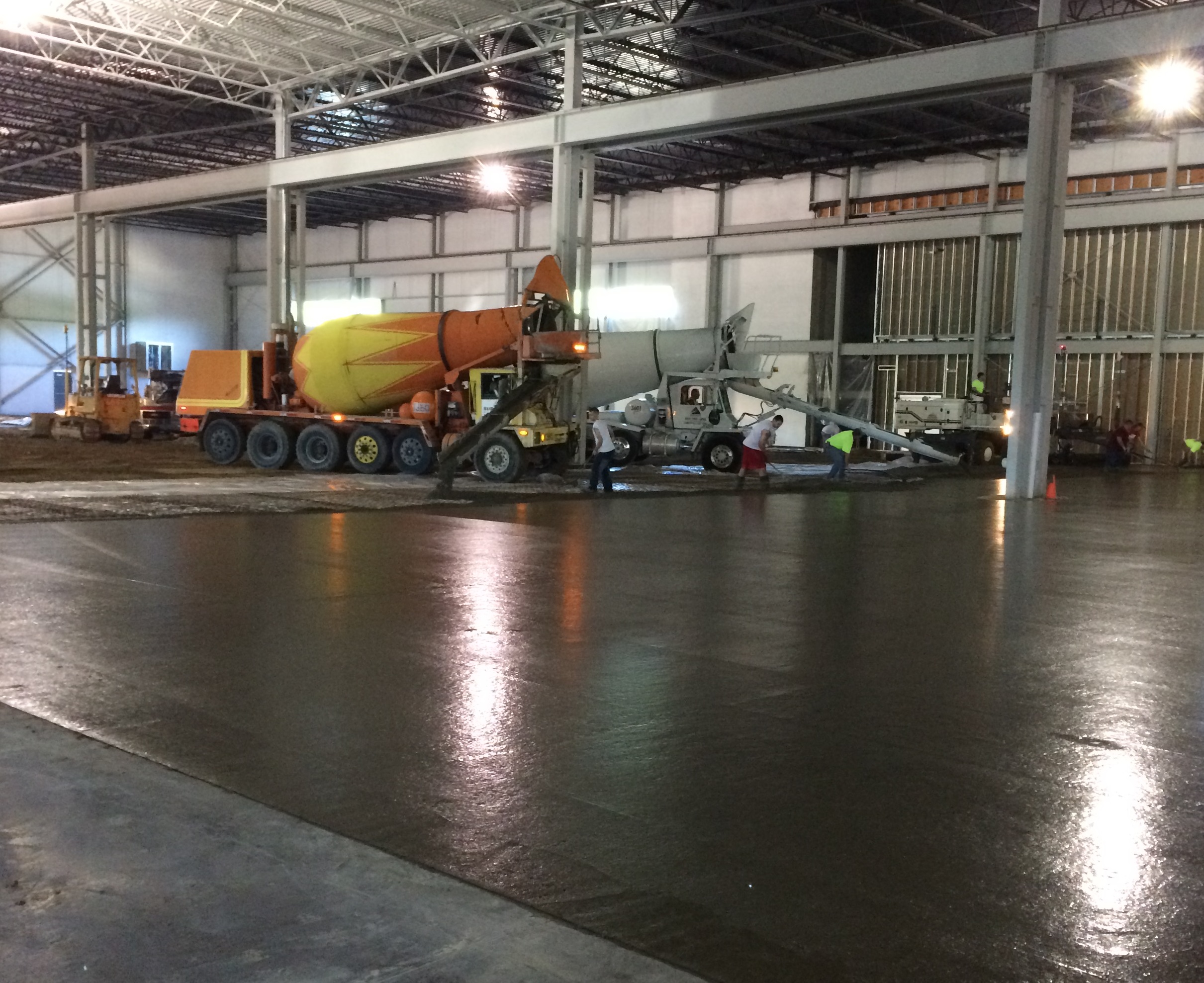 Contractors pour the new 174,000 SF shop floor with cement 8 inches thick. 