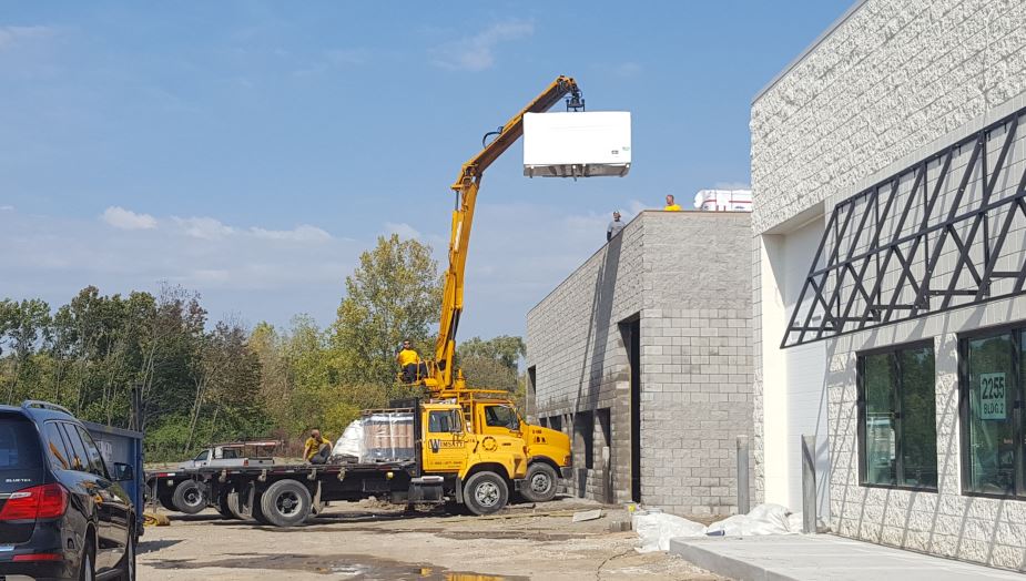 Insulation delivery to third building under construction